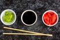 Set for sushi soy sauce ginger wasabi with chopstick on stone background Royalty Free Stock Photo