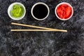 Set for sushi soy sauce ginger wasabi with chopstick on stone background Royalty Free Stock Photo