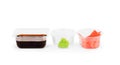 Set of sushi tablewear saucer with soy sauce, small white bowls for ginger and wasabi at white background Royalty Free Stock Photo