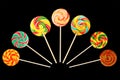 Set of sweet lollipop round shape isolated on black background for decorating confectionery products. multicolor caramel candies