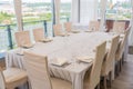 A set table with a beige tablecloth for 12 people. Panoramic view. Decanter of water on the table. Royalty Free Stock Photo