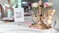 Set table for a wedding ceremony with decorations of candles and flowers with a Head Table sign