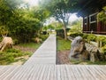 A set of tables and chairs in the corner of the garden, at the end of the wooden walkway