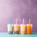 Set of tall drinking glasses with straws with Taiwanese bubble or boba tea from vegan milk and agava sypur with different flavors