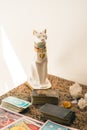 Set of a tarot reader on a table featuring various tarot decks, crystals, and a decorative cat Royalty Free Stock Photo