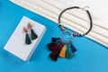 Set of tassel earrings and wood beads with colorful tassels and crystal beads necklace boho style on white scarf and blue paper