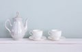 Set of tea cups and  ceramic teapot  on shelf Royalty Free Stock Photo