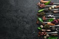 Set tea in spoons. Black, green, fruit and white tea. On a black stone background. Top view. Royalty Free Stock Photo