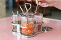 Set of Thai spices in glass jars on a table in a cafe Royalty Free Stock Photo