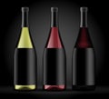 Set of three bottles of wine on a dark background