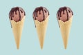 Set of three brown ice cream in crisp waffle cones with chocolate sauce on pastel green background, mock up.