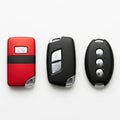 Set of three car key fobs in different colors and designs displayed side by side Royalty Free Stock Photo