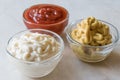 Set of Three Classic Sauce Ketchup, Mayonnaise and Mustard in Small Glass Bowls. Royalty Free Stock Photo