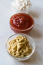 Set of Three Classic Sauce Ketchup, Mayonnaise and Mustard in Small Glass Bowls. Royalty Free Stock Photo