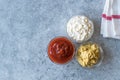 Set of Three Classic Sauce Ketchup, Mayonnaise and Mustard in Small Glass Bowls. Royalty Free Stock Photo