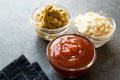 Set of Three Classic Sauce Ketchup, Mayonnaise and Mustard in Small Glass Bowls. Royalty Free Stock Photo