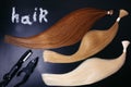 Set of of three colors hair extension tools on a dark background. copyspace. top view. Royalty Free Stock Photo