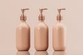 Set of three cosmetic bottles. Pump and floating bottle, liquid soap, shampoo dispenser. Blank Label. Cream or lotion on pink