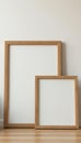 Set of three different sized wooden frames against neutral wall, modern setting, stylish, neutral wall, wall decor Royalty Free Stock Photo