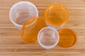 Set of round plastic food storage container on wooden surface