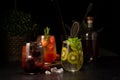 A set of three drinks with blackberry, kiwi and mint, tomato juice, cherry tomatoes