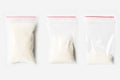 Set of three EMPTY, HALF AND FULL Plastic transparent zipper bag with Granulated sugar isolated on white. Vacuum package mockup wi