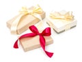 Set of three of gift boxes with presents wrapped in kraft paper and with golden and red bow isolated on the white background, gift Royalty Free Stock Photo