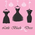 Set of three little black dresses hang on ribbons