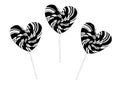 Set three lollipops in the shape of hearts, on sticks, in a strip. Black outline isolated on white background.