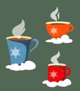 A set of three mugs standing in the snow, mugs with snowflakes and texture of snow.