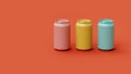 Set of three multi-colored classic aluminum beverage cans on a red background in the studio