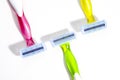 Set of three multi-colored female razors for shaving isolated on white background. Royalty Free Stock Photo