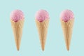 Set of three pink ice cream in crisp waffle cones on pastel green background, mock up for design. Royalty Free Stock Photo