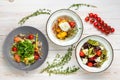 Set of three plates with vegetable salad. Healthy food for dieting. Lunch menu of food restaurant on white wooden background in