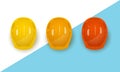 Set of three realistic construction helmets in different colors. Royalty Free Stock Photo