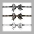 Set of three realistic gray black and white silk ribbon bow with gold glitter shiny stripes, vector illustration elements isolated Royalty Free Stock Photo