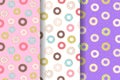 Set of three Seamless pattern of doughnuts with colored icing. Trendy beautiful donuts White, pink and purple background