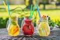 Set of three summer lemonade with ice and fruit like lemon, orange, lime and mint leaf, summer drink with soda isolated on white b