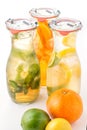 Set of three summer lemonade with ice and fruit like lemon, orange, lime and mint leaf, summer drink with soda isolated on white b