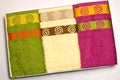 Set of three towels. Three towels of different colors are on a white background Royalty Free Stock Photo