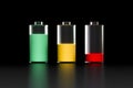 A set of three transparent batteries with different charge levels on a black background