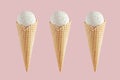 Set of three white creamy ice cream in crisp waffle cones on soft light pastel pink background, mock up for design. Royalty Free Stock Photo