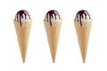 Set of three white ice cream in crisp waffle cones with chocolate sauce isolated on white background.