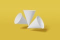 Set of three white paper mockup cups cone shaped fly on a yellow background. 3D rendering Royalty Free Stock Photo