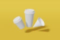 Set of three white paper mockup cups of different sizes - large, small and cone shaped fly on a yellow background. 3D rendering Royalty Free Stock Photo