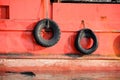 Set of tires on the side of a red ship for bumper protection Royalty Free Stock Photo