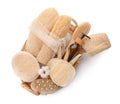 Set of toiletries with natural loofah sponges in wicker basket isolated on white, top view