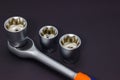 A set of tool heads for loosening screws, bolts and nuts. Ratchet screwdriver. Dark background Royalty Free Stock Photo