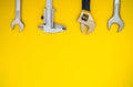 Set of tool for plumbers on yellow background with space for advertising Royalty Free Stock Photo