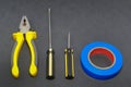A set of tools on a gray background pliers, screwdriver Royalty Free Stock Photo